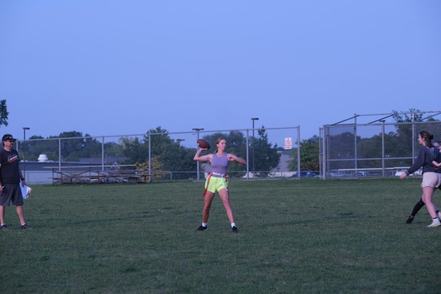 Junior Ava Pyeatt throwing the football after being passed the ball. On sept. 14, the junior powderpuff team practiced at the middle school. 