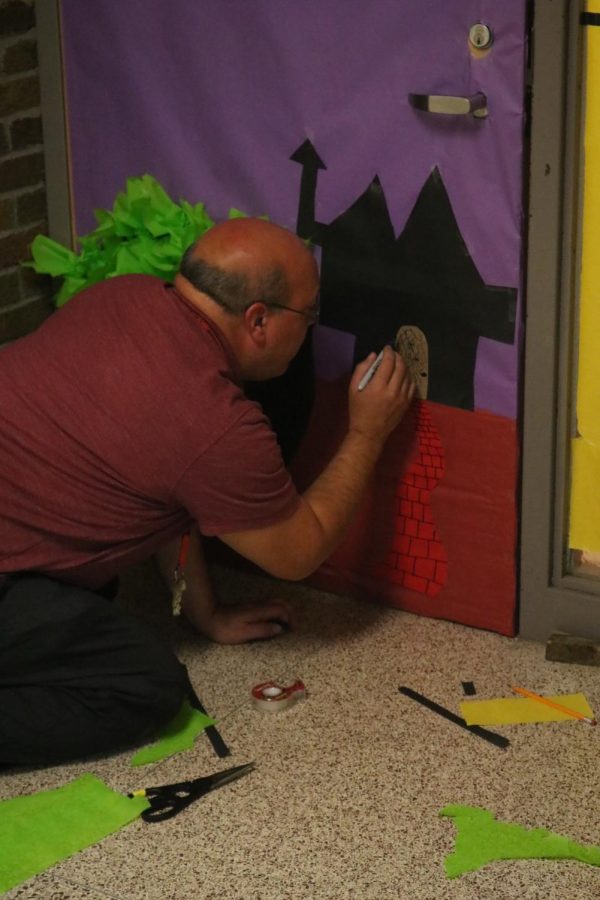 Drawing, FHS Literature and Composition teacher Lou Santo decorates his door. The student council accounced a Halloween door decorating contest; judging took place on Oct. 27. 