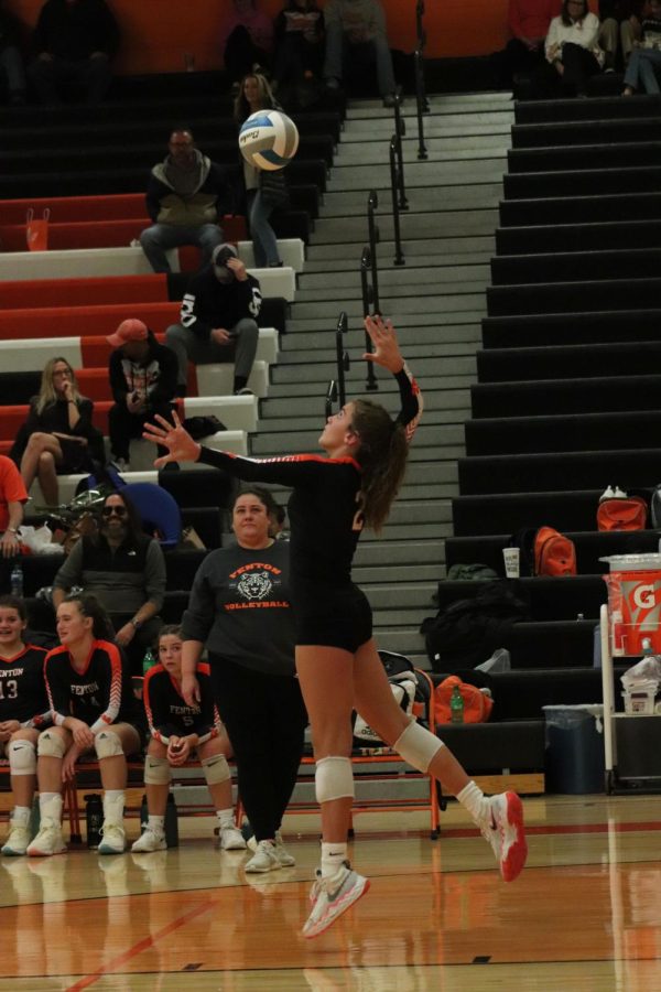 Jumping, freshman Eva Long serves. On Oct. 17, the varsity volleyball team played Kearsley and won 3-0.
