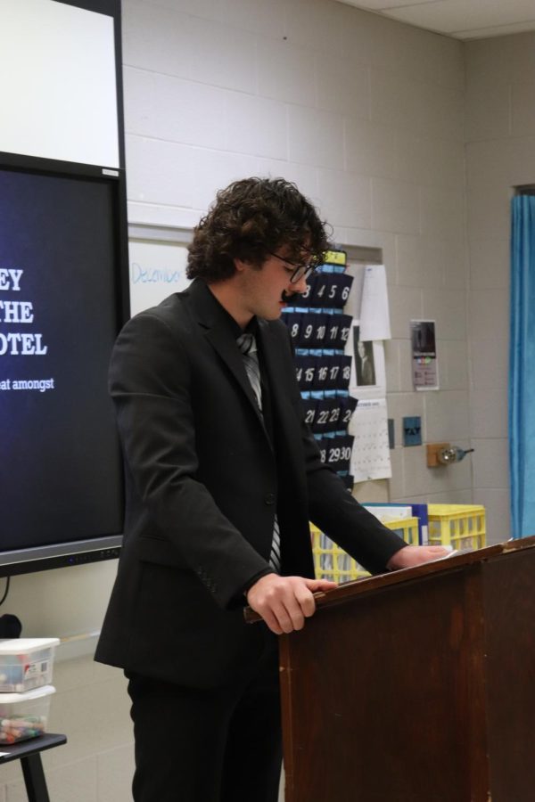 In costume, sophomore Jadon Burnau reads his speech. On Oct. 28, the FHS American Studies class held a tea party while learning about different progressive, historical figures. 