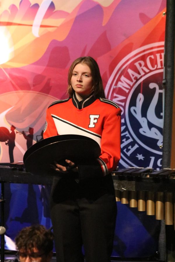Looking to the audience, junior Emerson Sayer performs for the FHS marching band. On Oct. 27, the Fenton High School bands performed at the annual Band-O-Rama in the auditorium. 