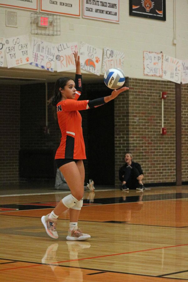 Preparing to serve, sophomore Alexa Ayotte tosses the ball into the air. On Sept. 28, the JV volleyball team played the Linden Eagles; winning 3-0.   