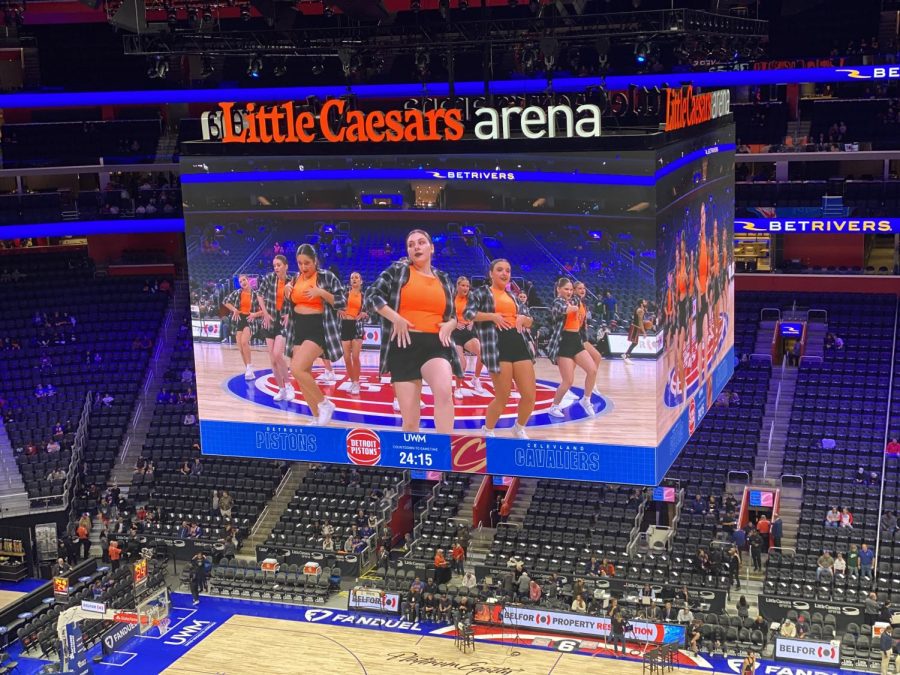 Hands on her hips, senior Amelia Price dances on the Jumbotron. On Nov. 27, the FHS varsity dance team performed at the Little Ceasars Arena before the Pistons game.
