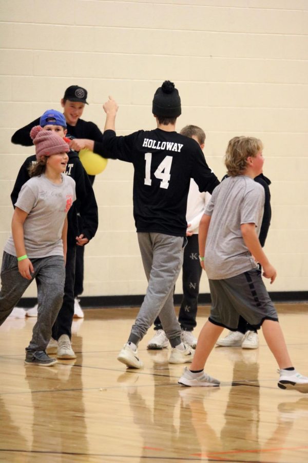 Senior Dylan Holloway directs the kids to their teams in dodgeball. On Nov. 18, the hockey team held a hockey lock-in for the local elementary students at the FHS high school.