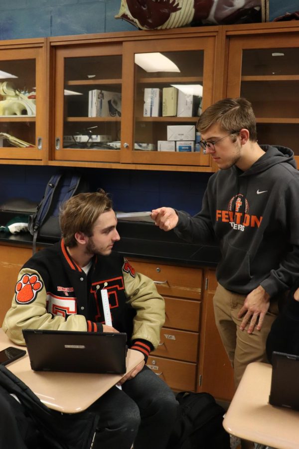 On Nov. 15, FHS anatomy & physiology classes performed a lab to test hearing and balance. Focusing on the sound, senior Remington Book listens to the tuning fork senior Caleb Markley holds against his forehead. On Nov. 15, FHS anatomy & physiology classes performed a lab to test hearing and balance. 