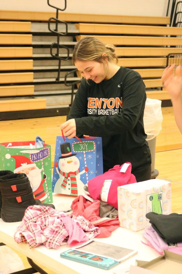 Wrapping gifts, junior Allison Mowery participates in gift wrapping for Angel Tree kids. The girls basketball program did Angel Tree shopping on Dec. 10 for the Play Like Jackson organization.