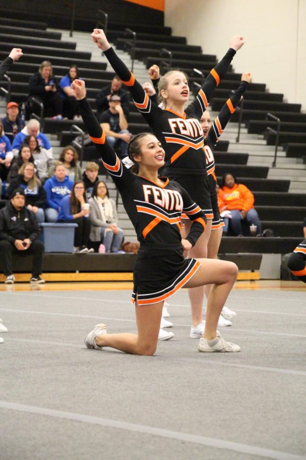 Smiling, junior Jillian Shanahan cheers to the crowd. On Dec. 10 Fenton Competitive Cheer Team competed against 14 other teams. They received 6th place with a score of 692.50