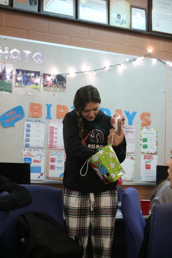 Looking into the bag, senior Evelyn Krusniak opens her gift. On Dec. 16 the Fentonian staff exchanged secret santa presents. A party also took place while celebrating the last day of school before winter break. 