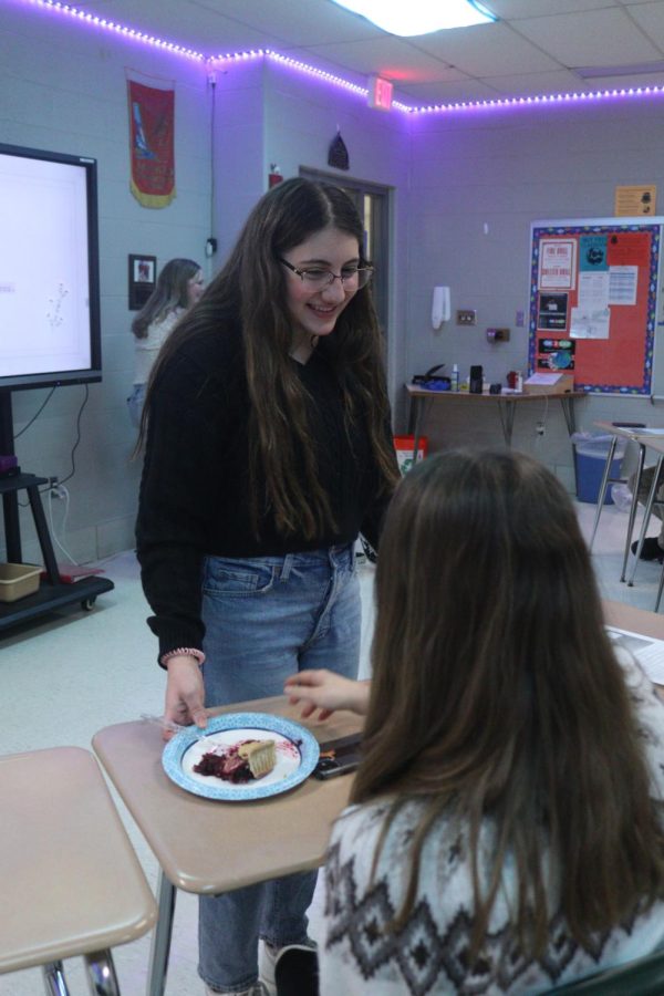 After presenting a virtual tour of England, freshman Haley Jensen passes out cherry pie. On Jan. 5, the freshmen Honors English and History classes made presentations about Elizabethan Era England. 