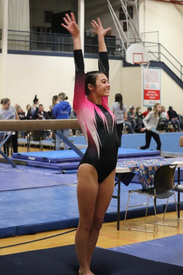 Saluting, junior Jillian Shanahan finishes her preformance on the fault. On Dec.16 the LFLF gymnastics team competed against Vassar High School.