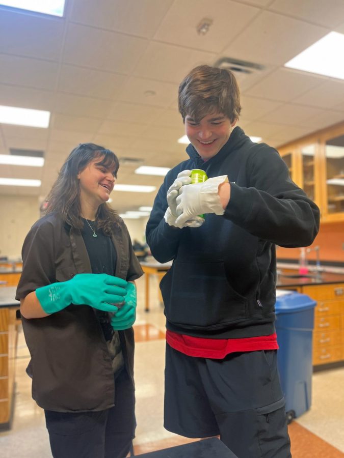 Laughing, senior Abby Logan and junior Chris Curtis sort recycling. On Jan. 24, the FHS E.C.O. Club gathered in the science teacher Nicholaus Jefferys room to organize recycling gathered from that week. 