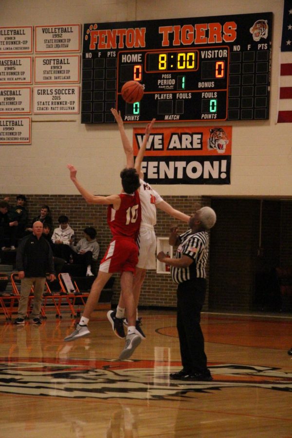 Jumping into the air, freshman Braxton Taylor reaches for the ball. On Feb. 2 the Frehman boys basketball team competed against swartz creek. They won their game 54-42. 