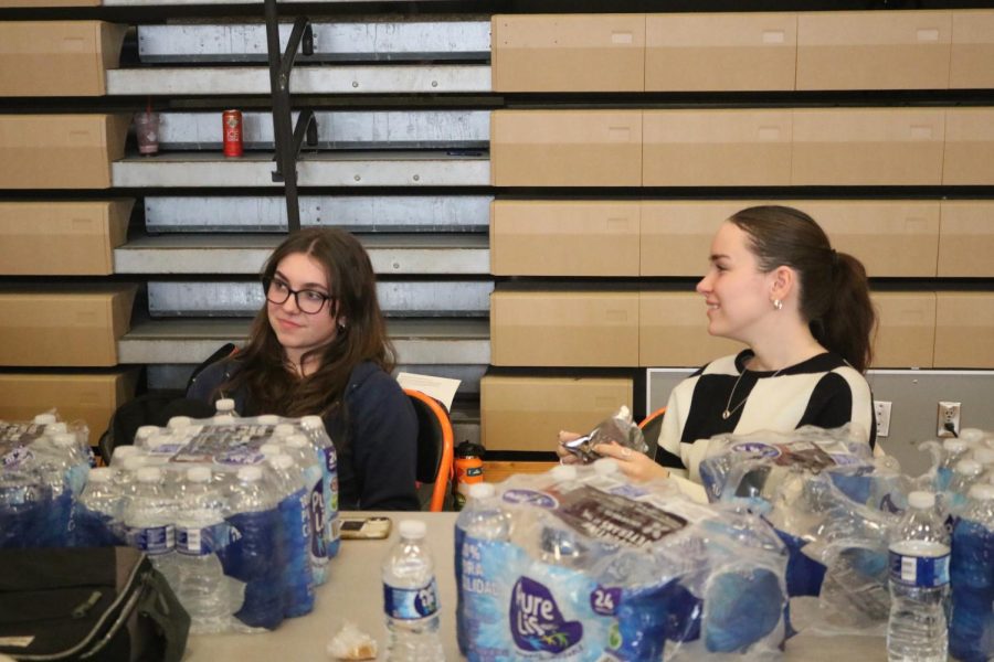 Volunteering from NHS, seniors Lauren Caldwell and Hailey Obrien hand out water to students who just got their blood drawn. On Feb. 3 FHS held a blood drive for staff and students. 