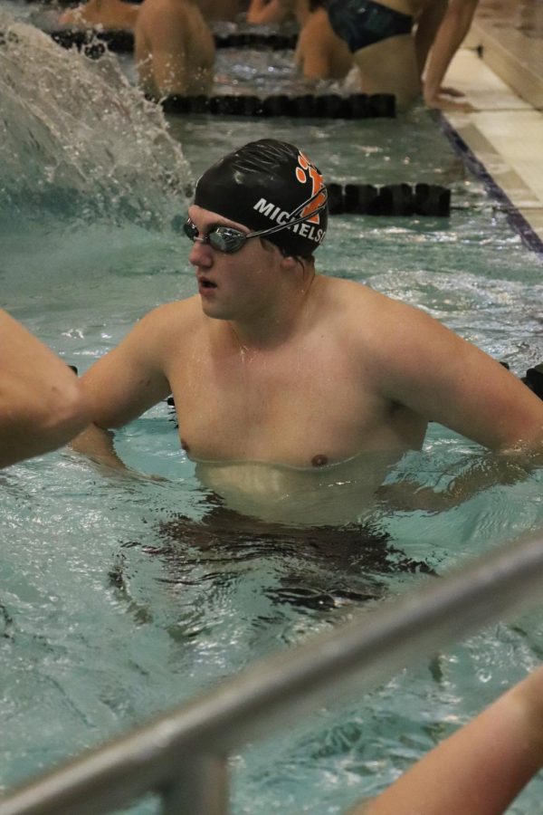 Warming up, senior Zachary Michelson prepares to take a practice lap. On Jan. 21, the boys varsity swim team competed at the Genesse County Meet; placing 2nd. 