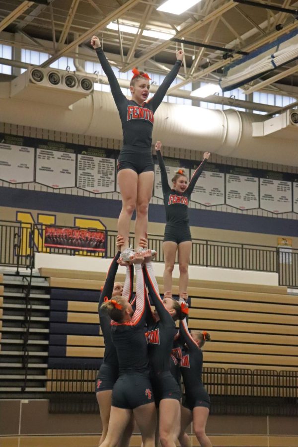 Stunting, freshman Evie Metcalfe and junior Avery Osborn are being held up by their teammates. On Jan. 21, the FHS competitive cheer team competed at the Hartland Heat Invite; placing second.
