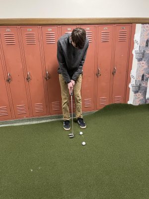 Junior Nathan Hiscock putts the ball. On. On March 22, The boys trying out start preparing for tryouts that are after spring break.