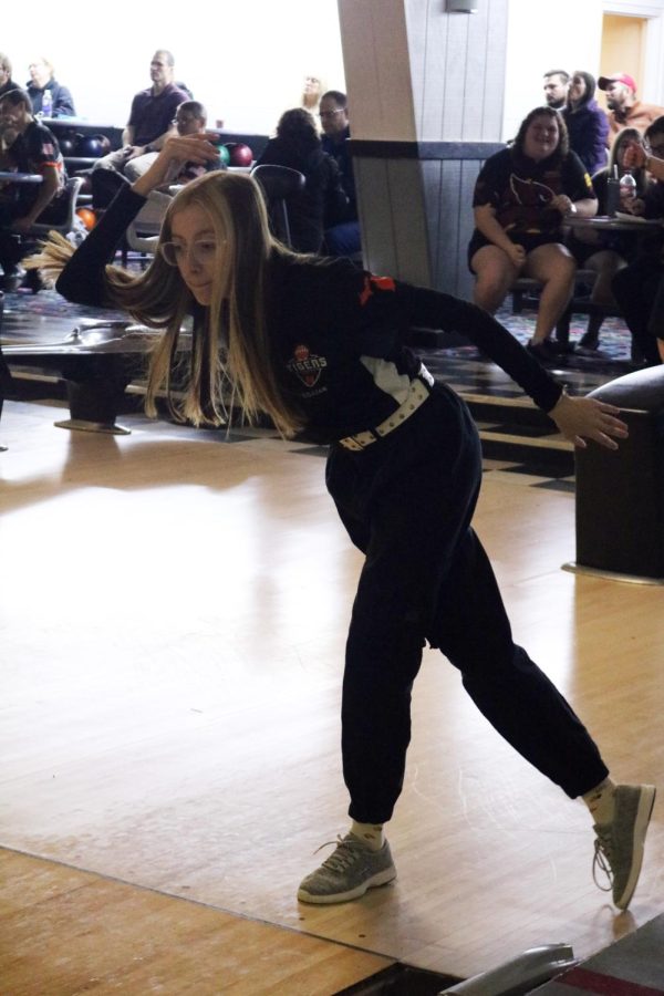 Sophomore Lillian Moore rolls the bowling ball toward the pins. On January 23, The FHS girls JV bowling team went up against Swartz Creek high.