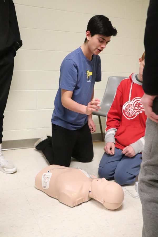 While preparing to start CPR, freshman Nathan Amar watches the mannequin. On March 1, FHS staff member, Becki Moore, held CPR procedures with her gym classes. 



