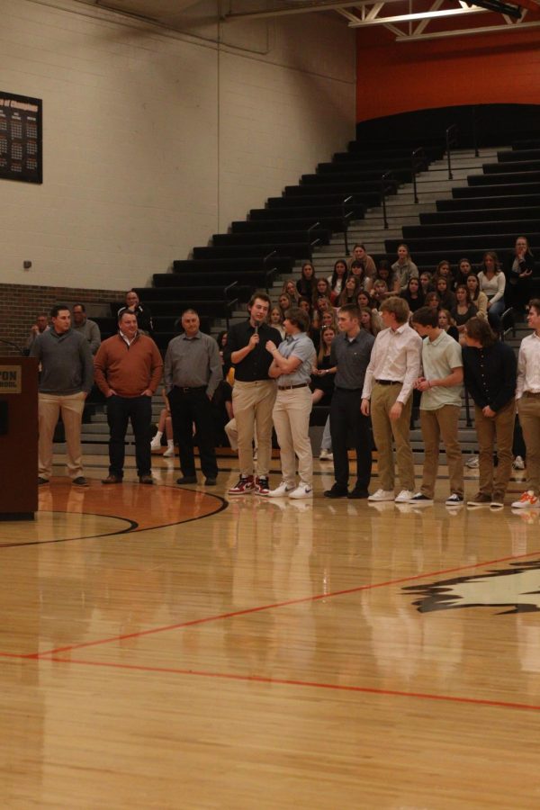 Saying his name to the crowd, senior Kyle Crow gets ready to pass the microphone to his teammate. On March 21, FHS held a spring meet the team to introduce each sports team for the season. 