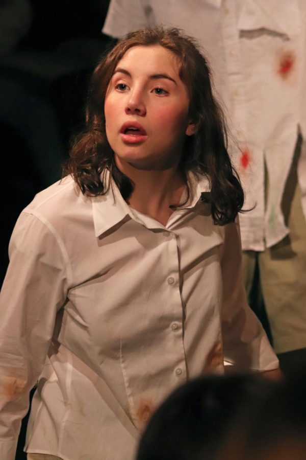Acting, senior Hana Cashmere peers into the audience. On March 9, the FHS IB Theatre performed a student show of The Lord of the Flies.