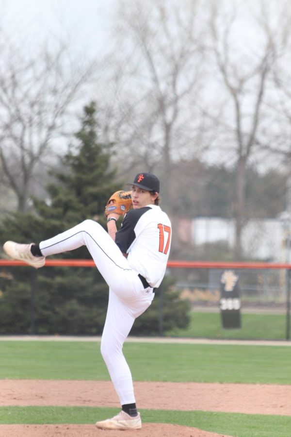 Preparing to throw, senior Kyle Crow pitches a baseball. On April 19th, Fenton versed Holly and won 16-1. 
