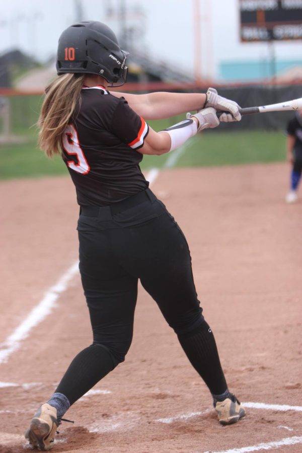 Swinging her bat, freshman Marlee Topij hits the ball. On April 19 the Fenton JV softball team competes against Lakeland and won their game. 