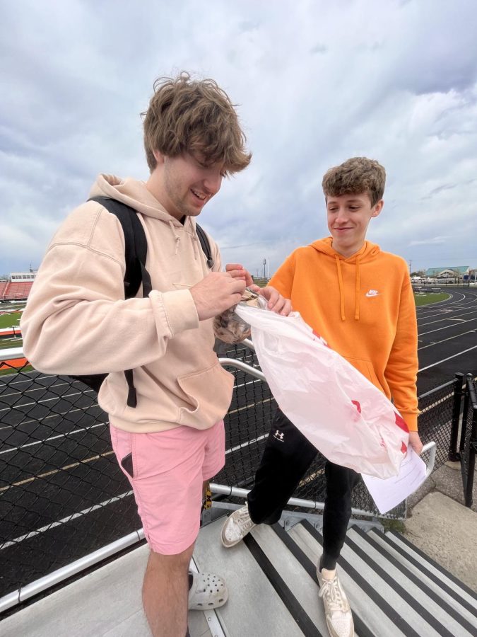 Unwrapping their project, senior Hunter Vieu and junior Zane Nelson check to see if their egg broke. On April 20, Physics teacher, Jason Kasak, took his class to the football field to demonstrate their egg drop devices. 