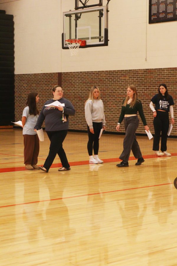 Following FHS teacher and National Honors Society advisor Vera Hazlett, sophomore Jensen OBrien practices for induction. On April 27, NHS officers and inductees rehearsed for the induction that will take place on May 4. 