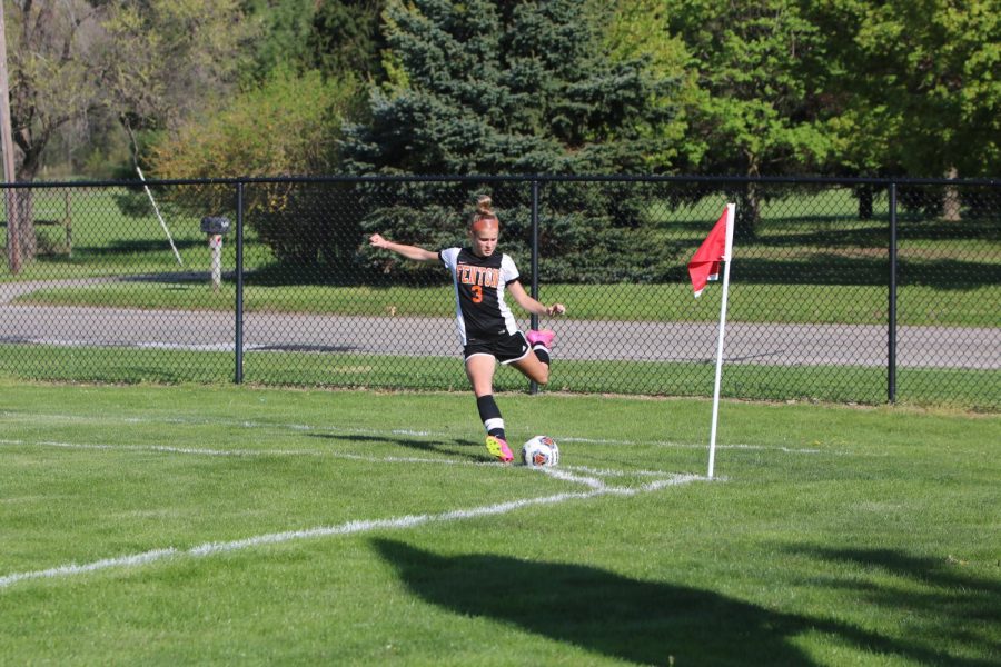 Kicking the ball, freshman Lauren Chapple takes a corner kick. On May 10, the jv soccer team beat flushing with a score of 2-0.
