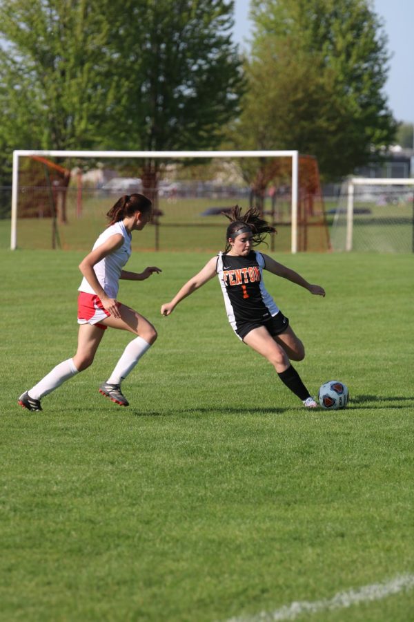 Kicking the ball, freshman Tessa Katsef passes the ball to a teammate. On May 11, the JV soccer team beat Holly 1-0.
