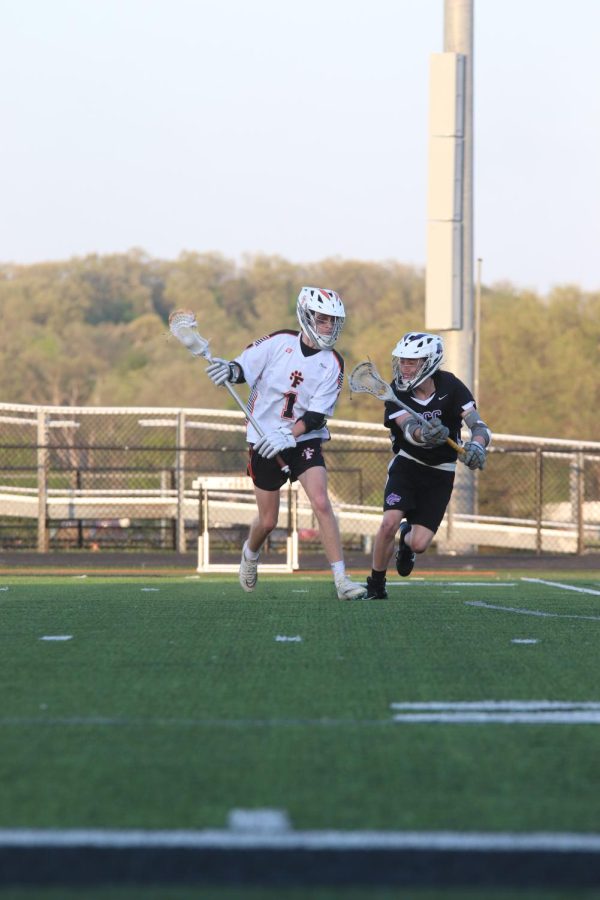 Looking to the goal, sophomore Owen Mueller runs with the ball. The Fenton boys varsity lacrosse team went up against Bay City Central on May 11, and won 18-3.