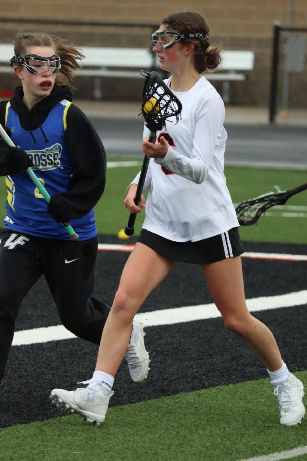Cradling the ball, sophomore Paige Harrison runs up the field. On May 2, the Fenton-Linden Heat Lacrosse team played Lake Fenton-Goodrich; winning 21-19.