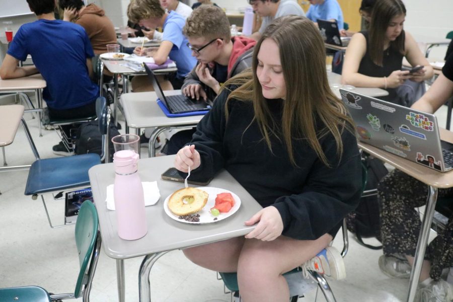Eating, senior Ella Forcia picks up a grape. On May 9, Advanced Placement teacher Renee Muzers class had a party during second hour. 