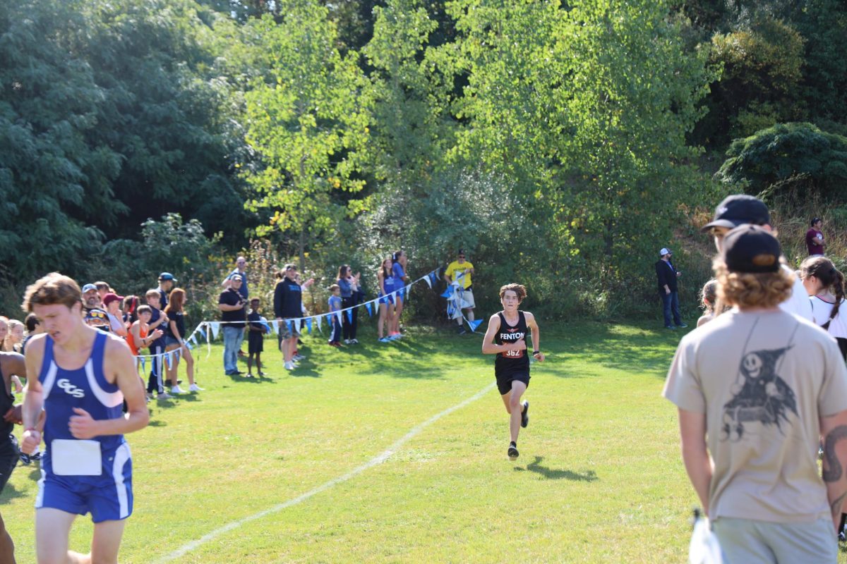 Running through the final leg in the meet, junior Ethan Brzezinski races through the finish line. On sept. 23, Fenton competed in the 40th Linden Classic Invitational at Linden Highschool. 