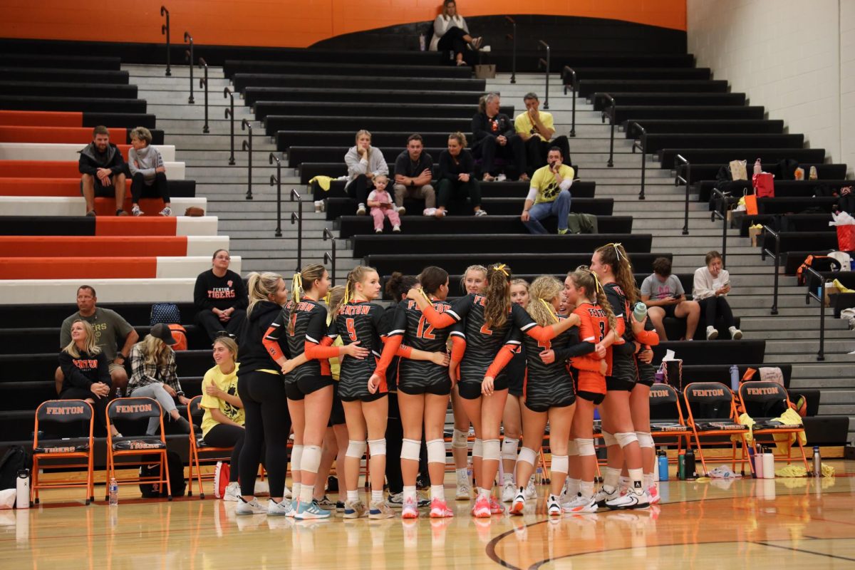 Huddled up, senior Olivia Shampo celebrates with her team in their Go Gold volleyball game. Sept. 13 the tigers beat the hornets 3-0.