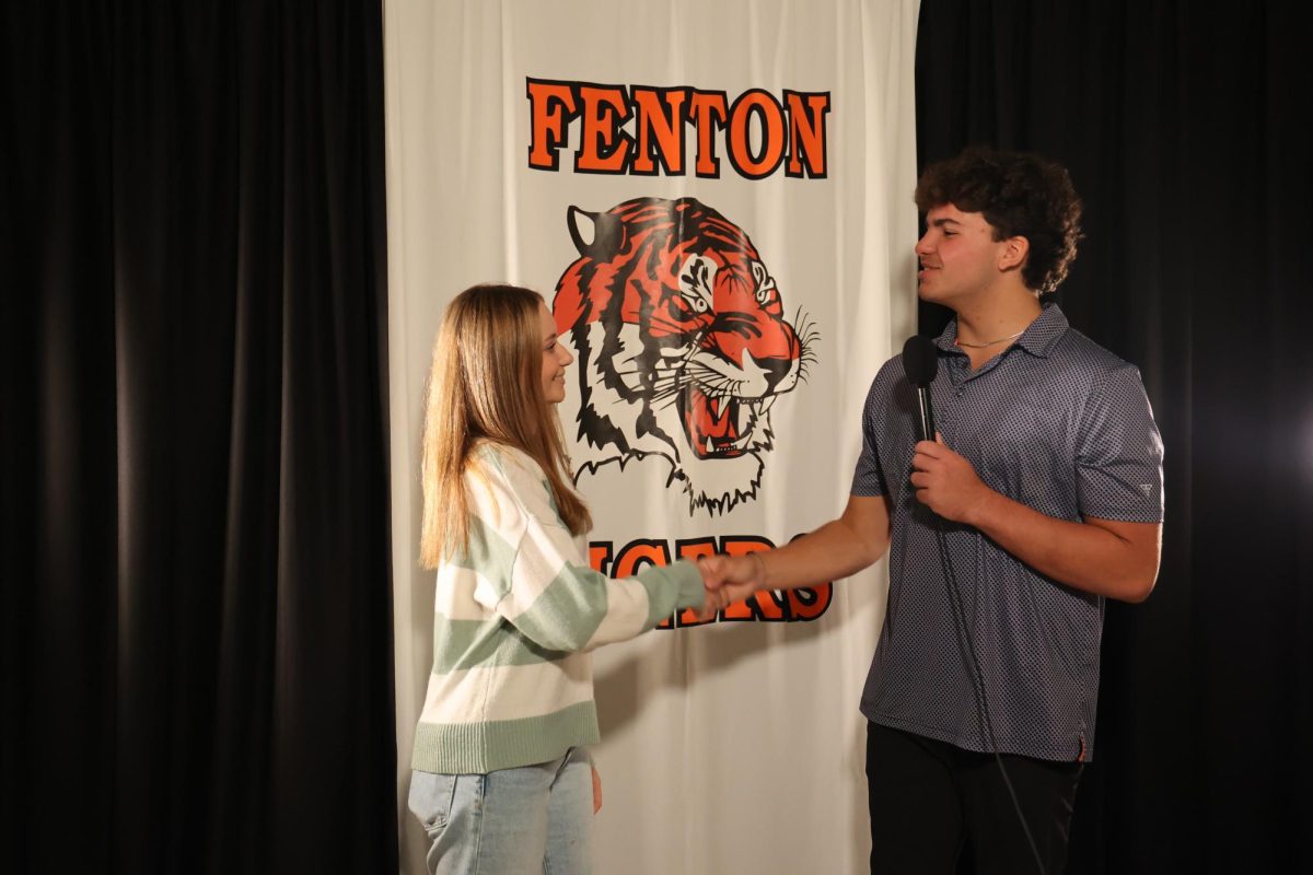 Shaking hands, senior Emma Minock meets with senior Carson Krzeszak. On Sept. 28 she completed her homecoming court interview.