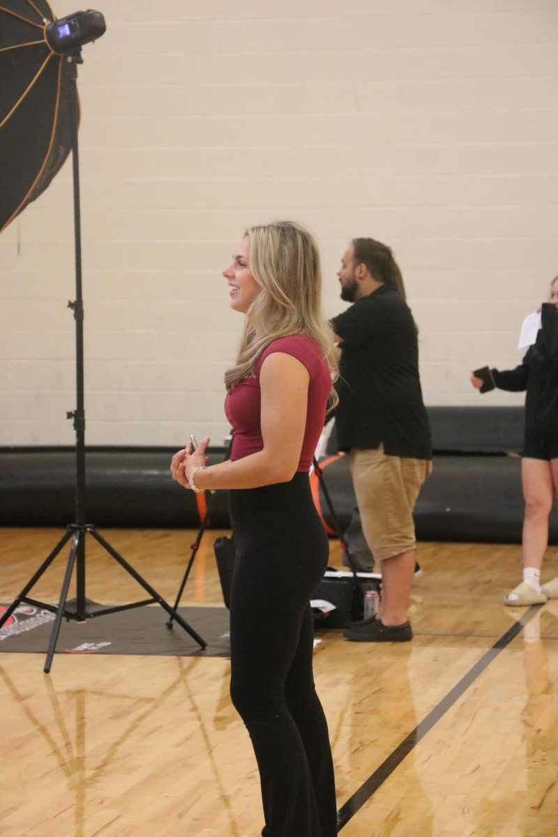 Preparing for her photo, senior Chloe Justus waits in line. On Sept 12. picture retakes took place in the auxiliary gym. 