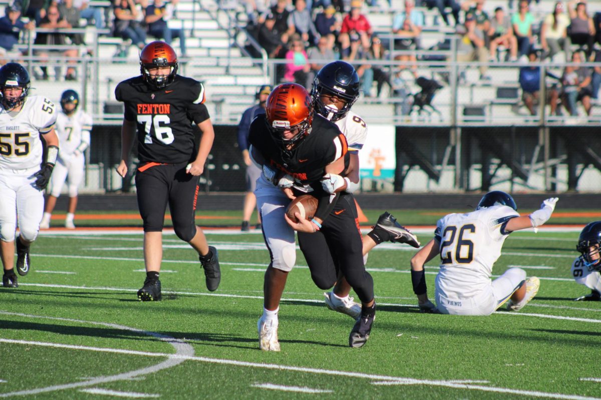 Running the ball, Sophomore Luke Dotson attempts to score a touchdown against Haslett. On Aug. 30 the JV football team had a out of conference match up only winning 39-32. 