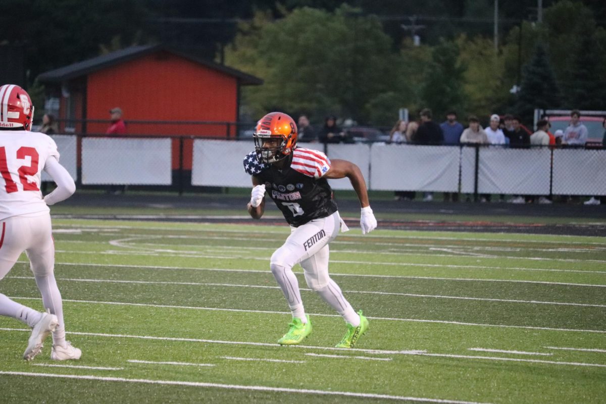 Getting ready for the next play, Senior JaHion Bond is running after his opponent. On Sept. 8. Fenton Varsity Football played against Swartz Creek winning 47 - 12.