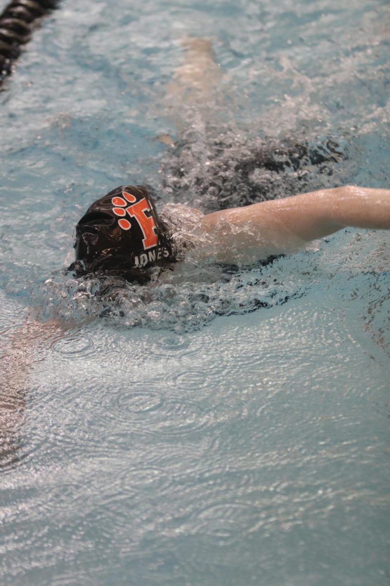Freshman Sophie Jones completes a freestyle during her swim meet on Sept. 23.