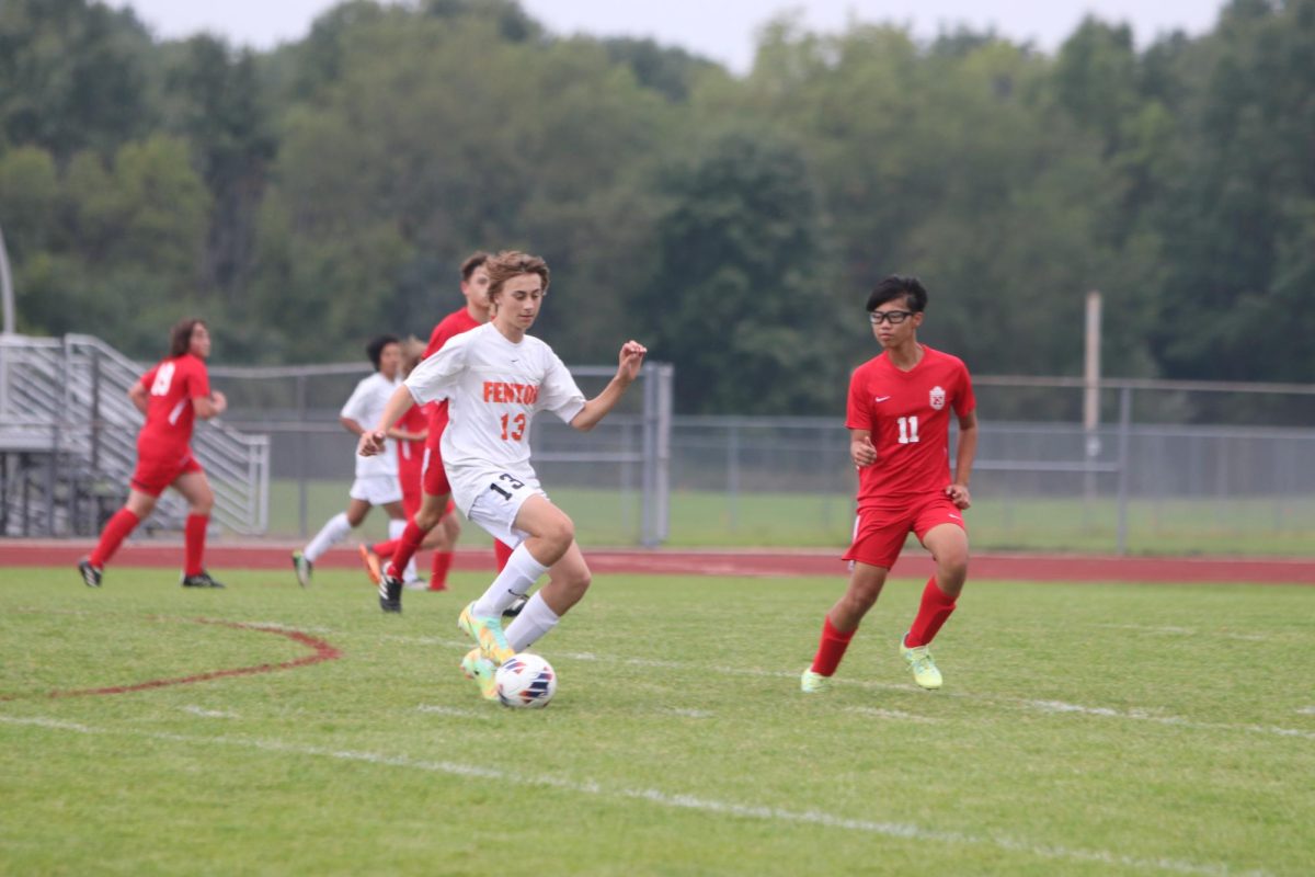 Advancing the ball up the field, Sophomore Dane Mckee, helps lead his team to a win. On Sept. 11th, the Fenton tigers competed against Holly and won 2-0. 