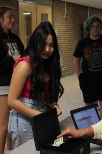 Waiting in line, sophomore An Nguyen buys her ticket for homecoming. On Sept. 27, Student Council sold tickets during both lunches.