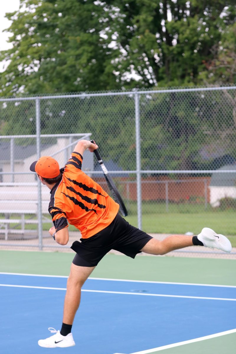 Serving the ball, Senior David Verna goes up against his opponent. On Sept. 12, the FHS boys varsity tennis went up against Clio losing 1-7.