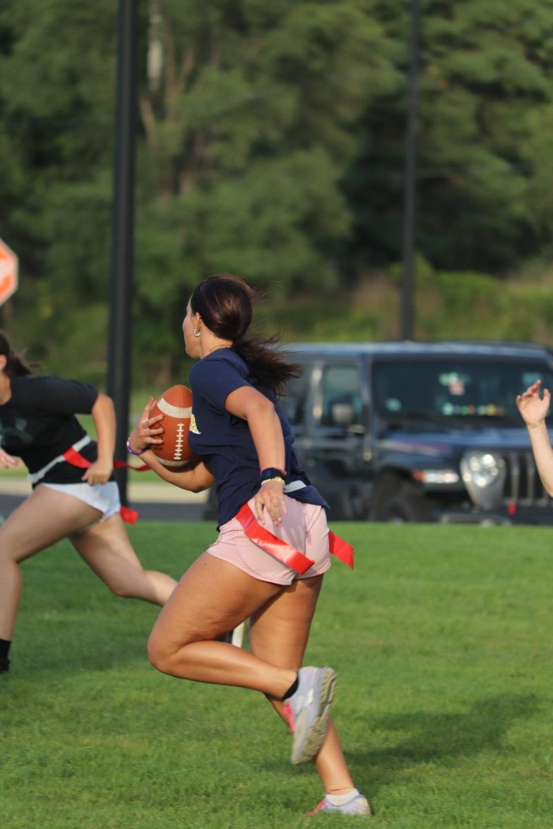 Racing towards the end zone, Senior Sophia Resa heads for a touchdown. On Sept. 12, the seniors had powder puff practice before their game.

