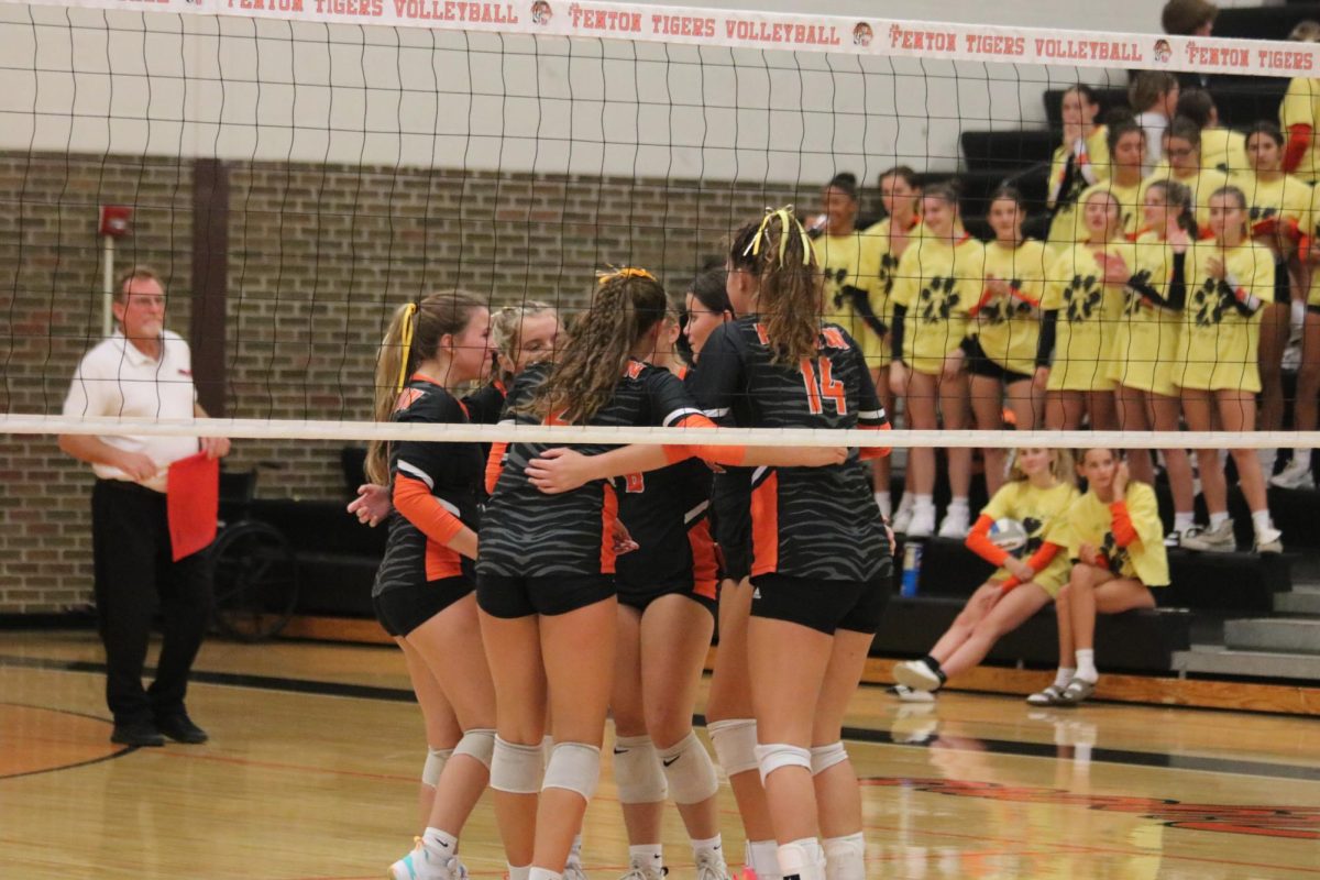 After just scoring, the Fenton varsity girls volleyball team is circled up ready to go to their next formation. the varsity girls beat Kearsley on 9/13. 