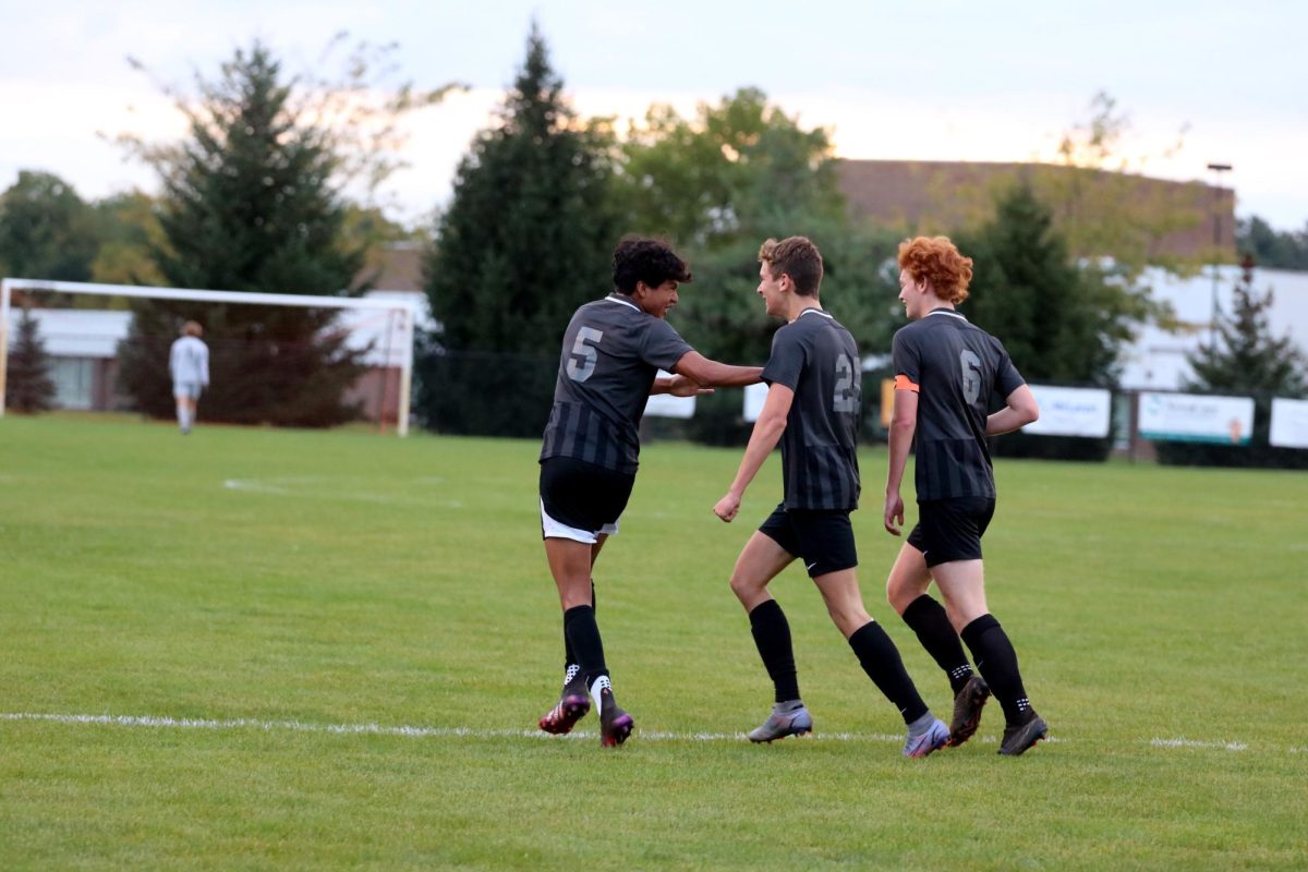 After scoring seniors Christian Gomez, Jake Chapple and Dylan Katzenberger celebrate. On Sept. 18, The FHS varsity boys soccer team went up against Corunna at our home field winning 7 to 0.