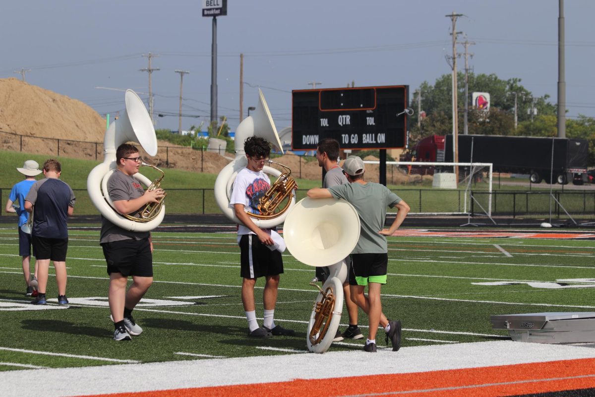 Tuba players discuss their previous. Taking a break, on July 26, they woke up to practice marching.