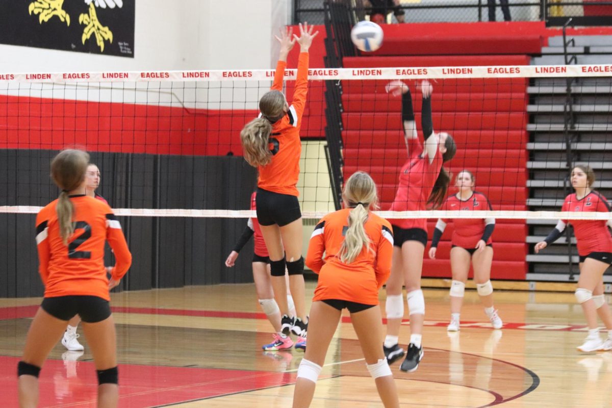 Going up for a block, freshman Brinlee Fitzer attempts to earn a point for her team. On Sept. 20, the freshman volleyball team beat Linden, winning all three sets.