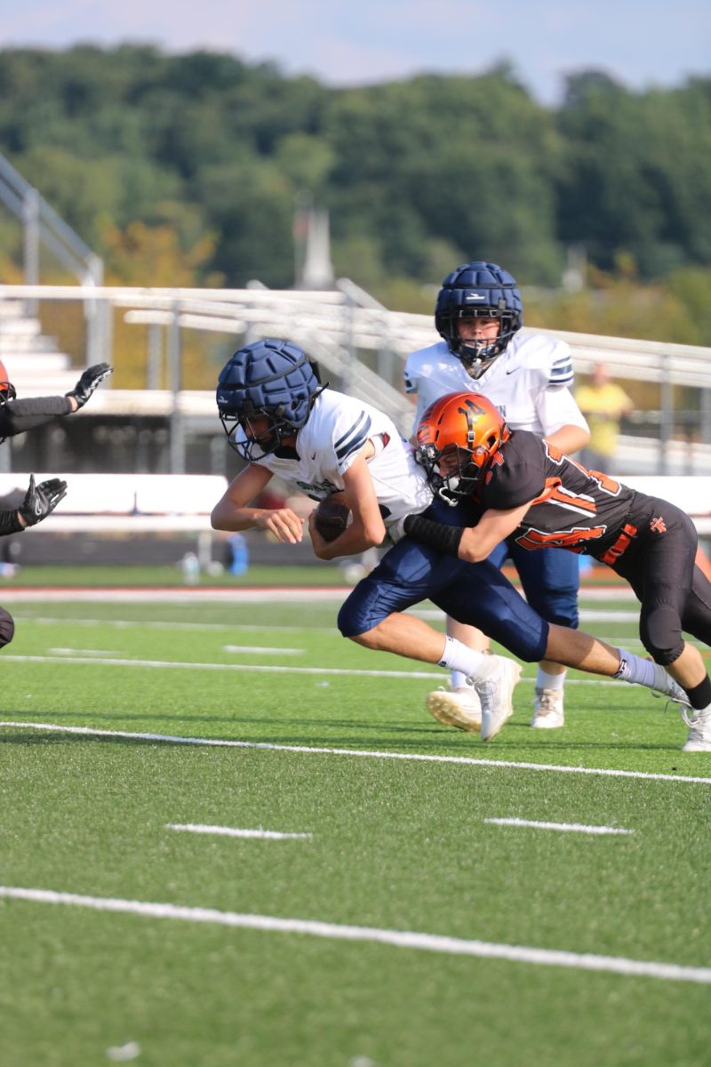 Completing the tackle, Freshman Gregory Serge stops a first down. On Sept. 21, the FHS Freshman Football team went up against South Lion losing 12 to 28