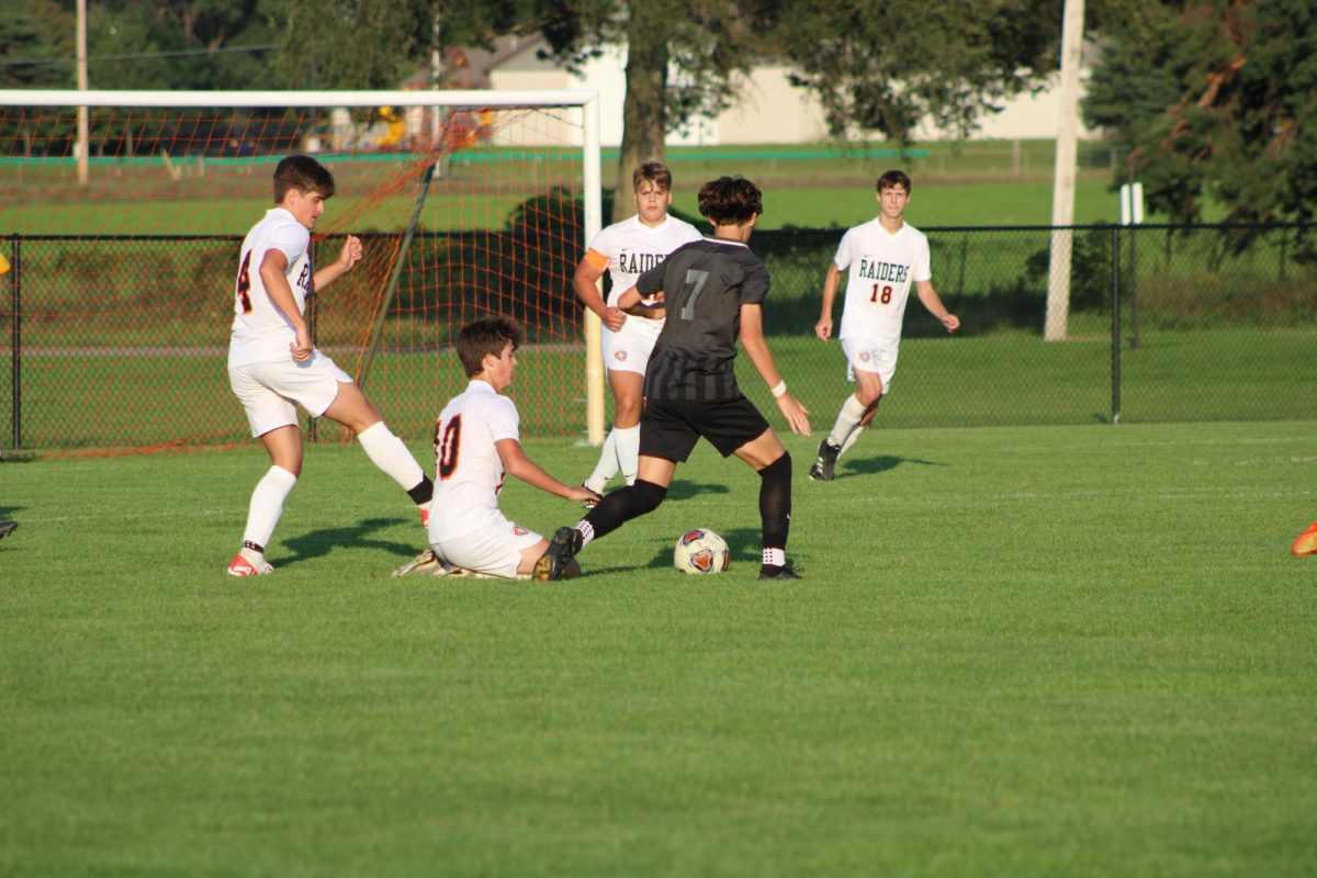 Dribbling, sophomore Dillon Hamilton approaches the net to try and score a goal. On Aug. 28, the varsity soccer team played Flushing with a 2-3 loss. 